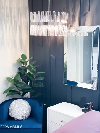 a bathroom with a sink a mirror and a potted plant