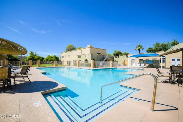 an outdoor view of the house with swimming pool