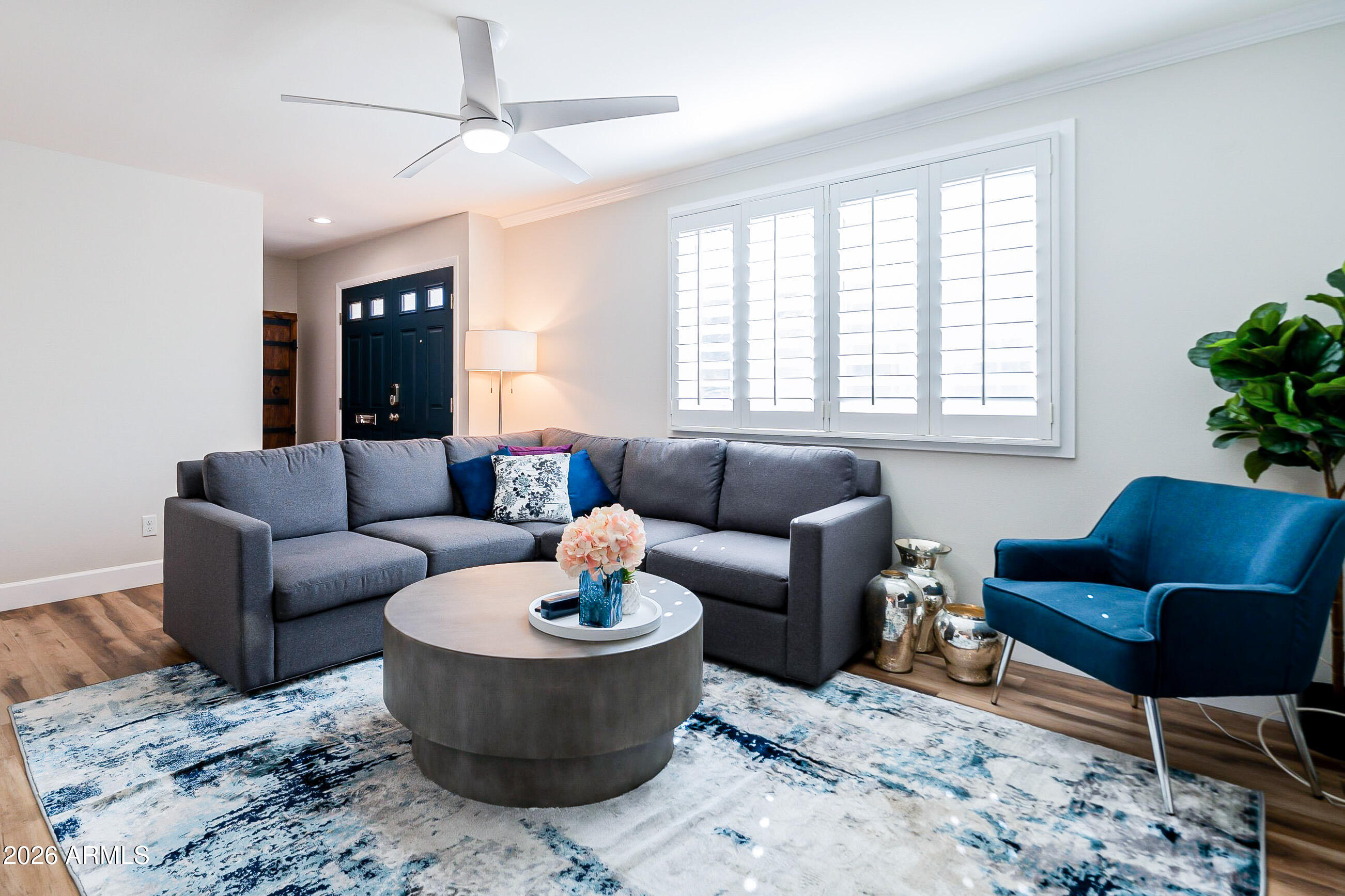 4243 North Miller Road Scottsdale, AZ 85251 - Photo 3 of 24 a living room with furniture and a potted plant
