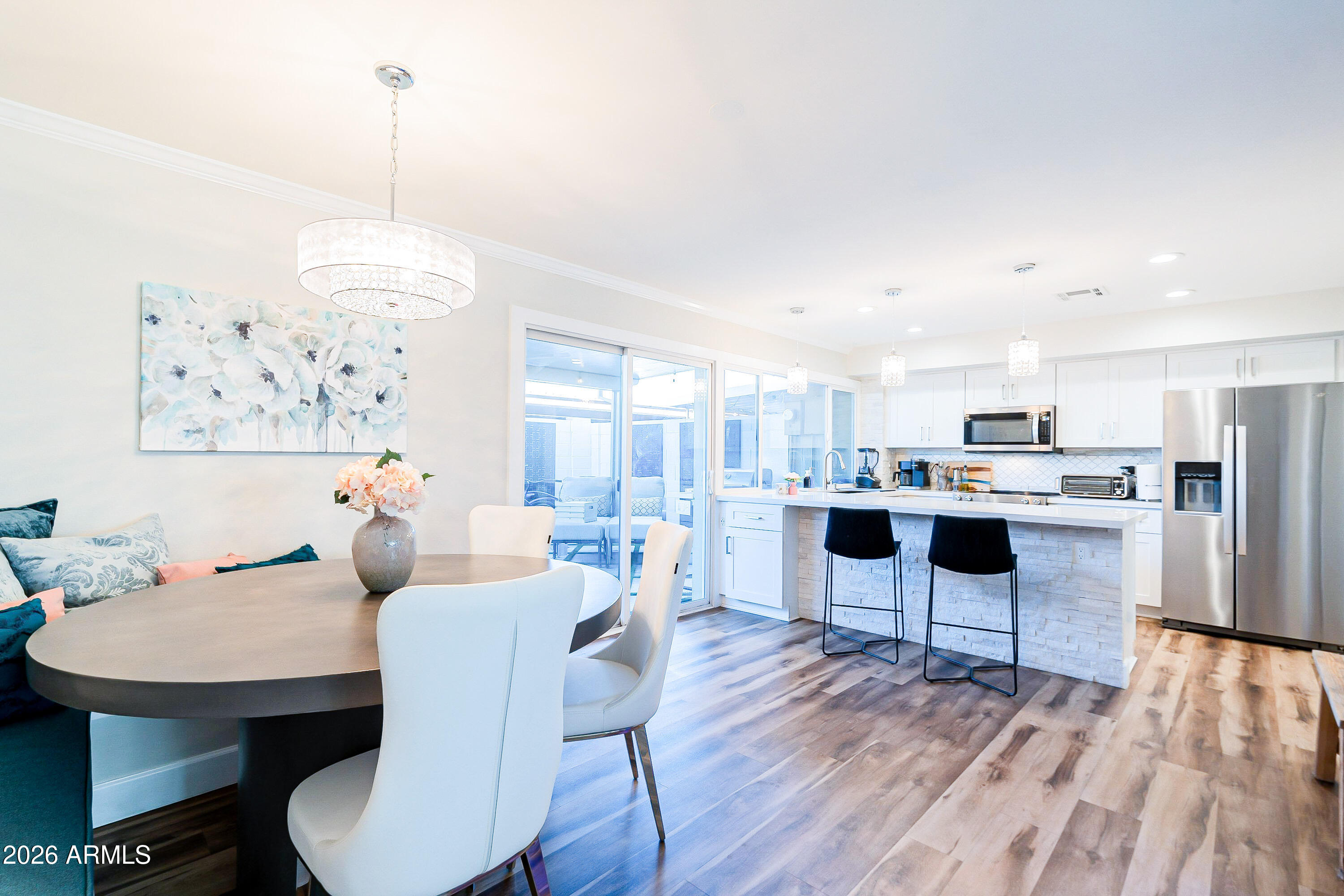 4243 North Miller Road Scottsdale, AZ 85251 - Photo 6 of 24 a view of a dining room with furniture window and wooden floor