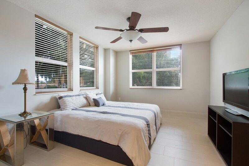 99 Southeast Mizner Boulevard, Unit 201 Boca Raton, FL 33432 - Photo 8 of 14 05_99SEMiznerBlvd201_14_MasterBedroom_Fl