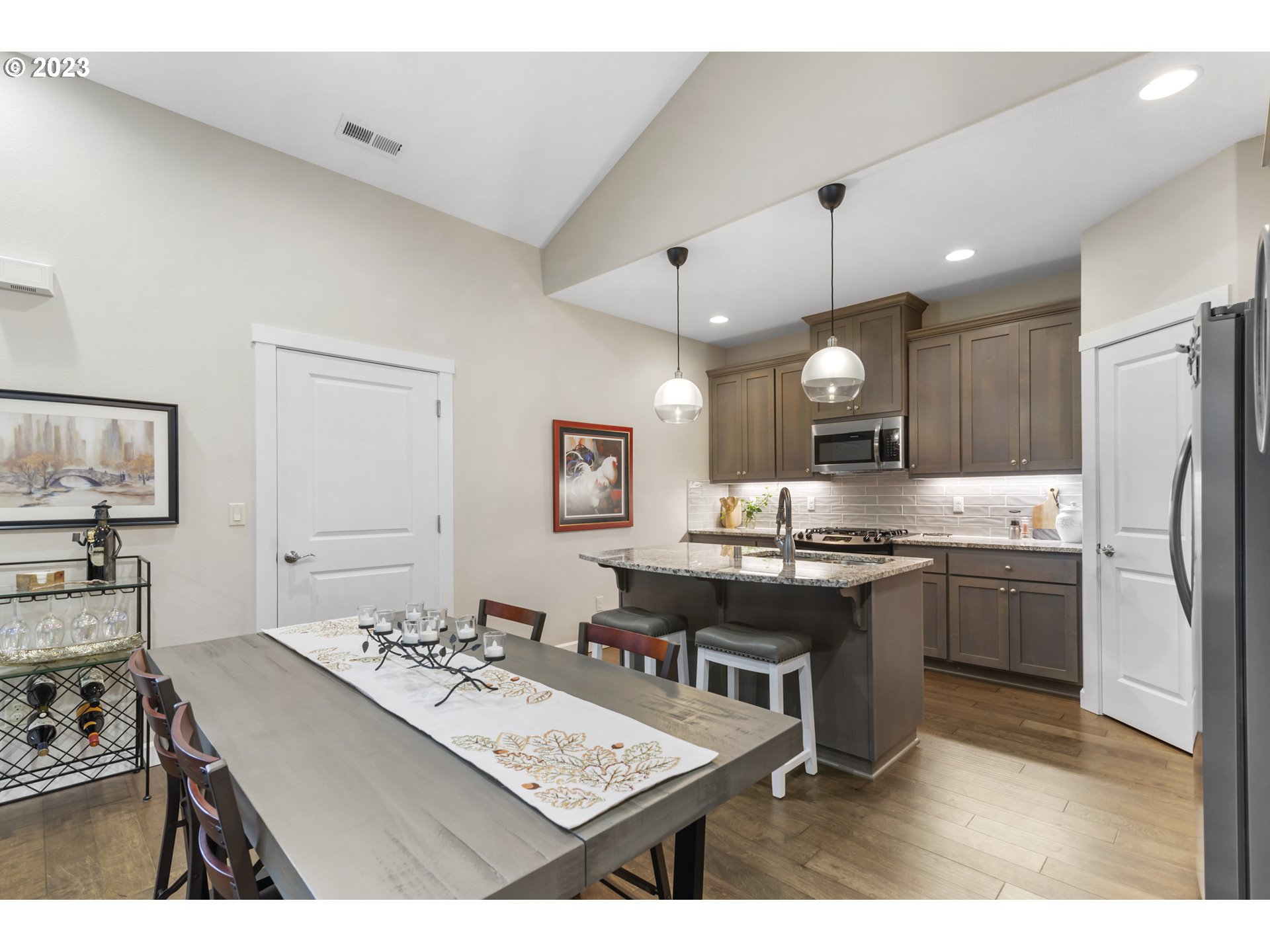 17402 Northeast 16th Avenue Ridgefield, WA 98642 - Photo 11 of 32 a kitchen with a sink a stove a refrigerator and a dining table