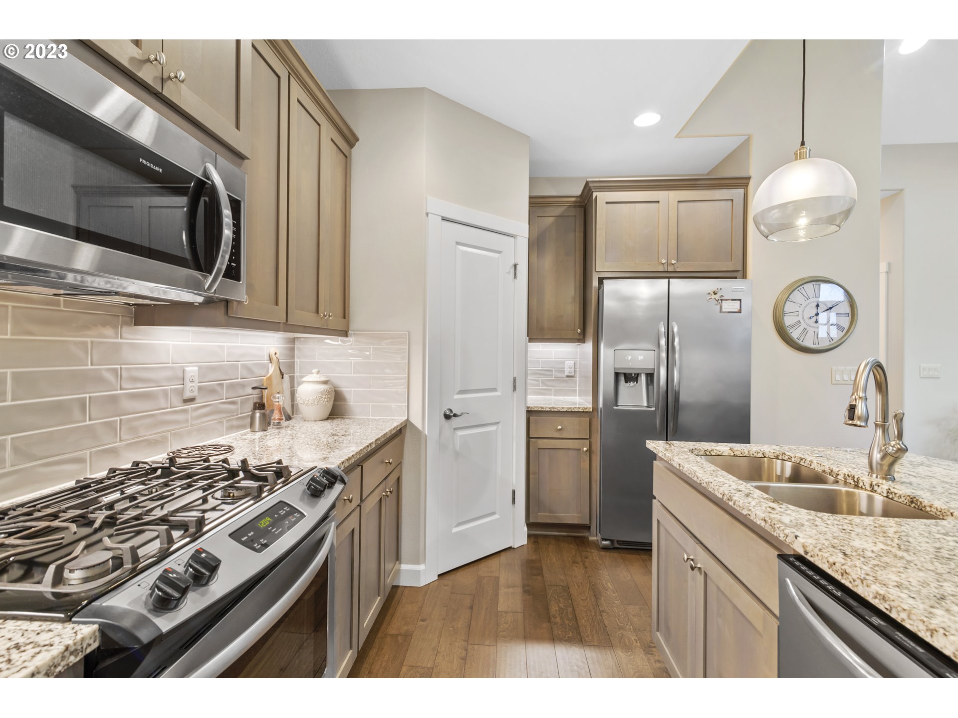 17402 Northeast 16th Avenue Ridgefield, WA 98642 - Photo 13 of 32 a kitchen with a sink stove and refrigerator