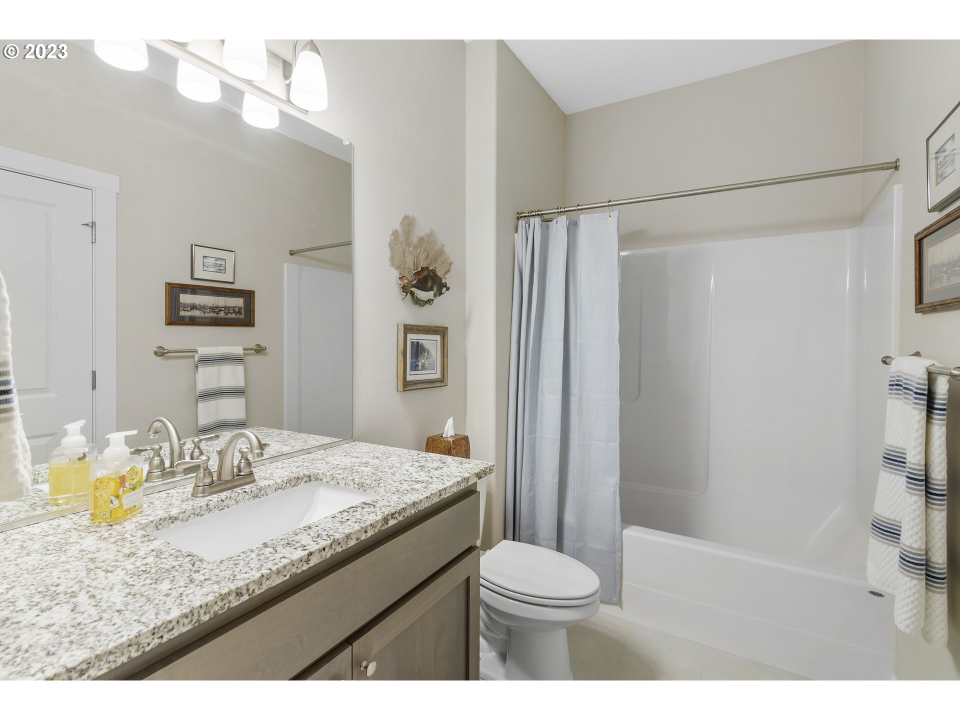 17402 Northeast 16th Avenue Ridgefield, WA 98642 - Photo 18 of 32 a bathroom with a granite countertop sink toilet and shower
