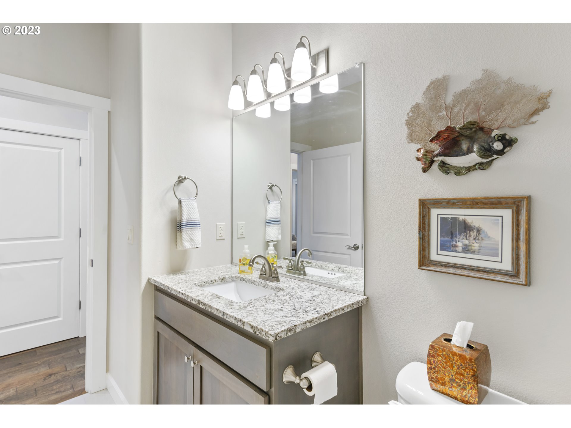 17402 Northeast 16th Avenue Ridgefield, WA 98642 - Photo 19 of 32 a bathroom with a granite countertop sink a mirror and vanity