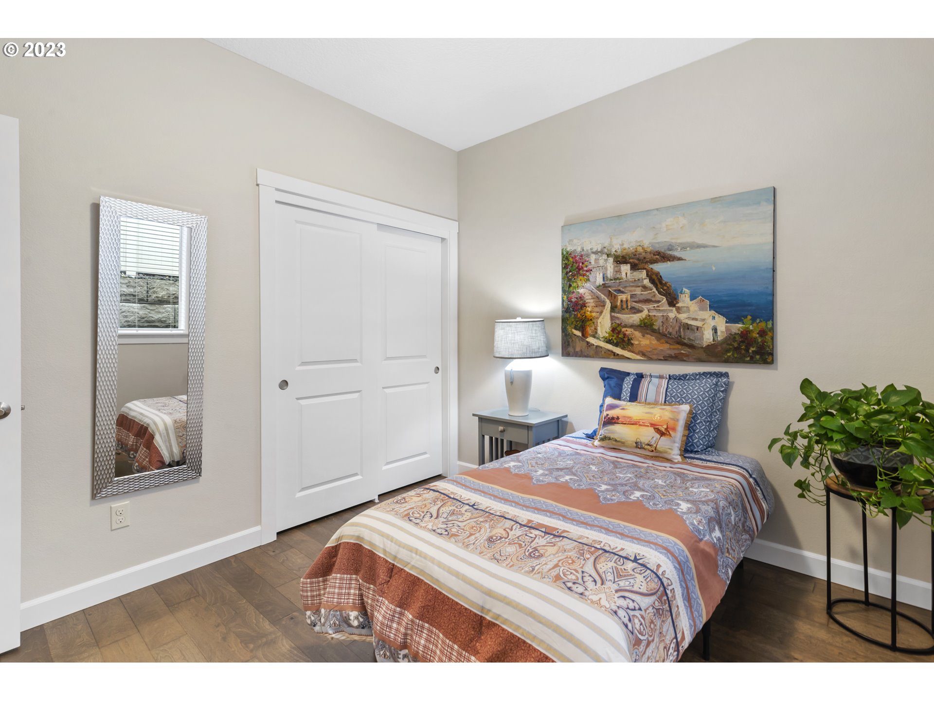 17402 Northeast 16th Avenue Ridgefield, WA 98642 - Photo 28 of 32 a bedroom with a bed and a painting on the wall