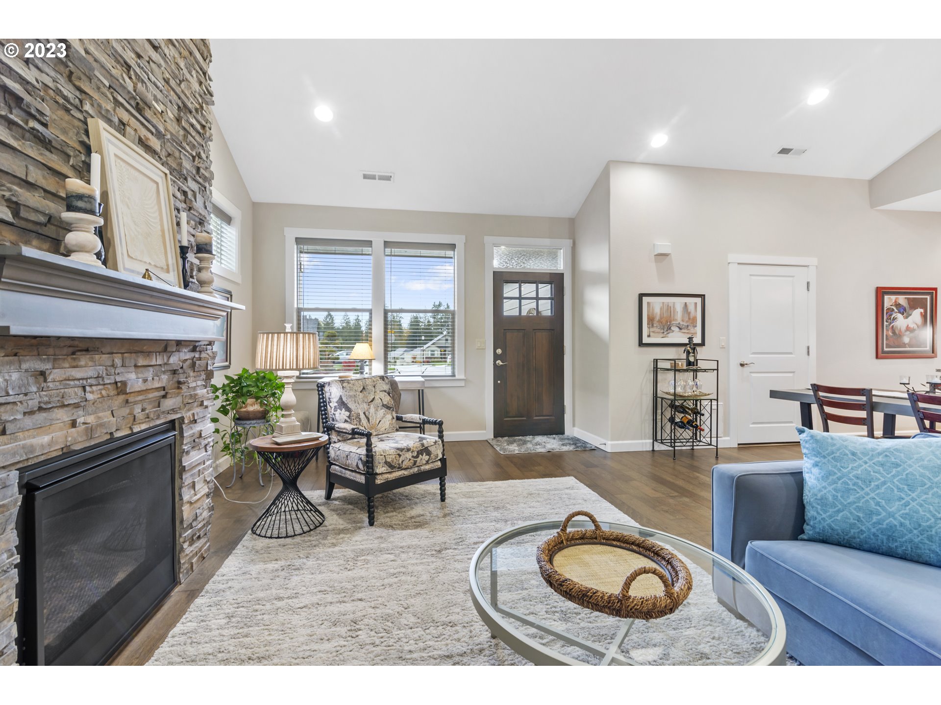 17402 Northeast 16th Avenue Ridgefield, WA 98642 - Photo 7 of 32 a living room with furniture a fireplace and a floor to ceiling window