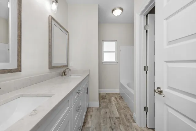 a bathroom with a sink a mirror and a shower