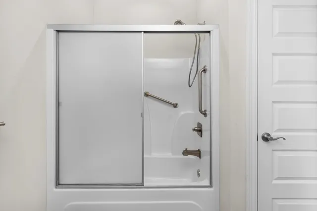 a bathroom with a glass shower door