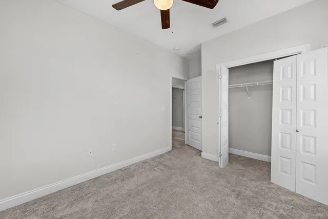 an empty room with ceiling fan