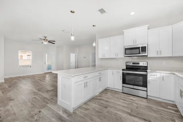 a kitchen with granite countertop a stove and a sink