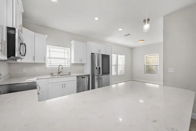 a kitchen with stainless steel appliances granite countertop a refrigerator sink and cabinets