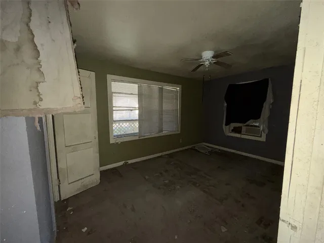 a view of an empty room with a fireplace and a window