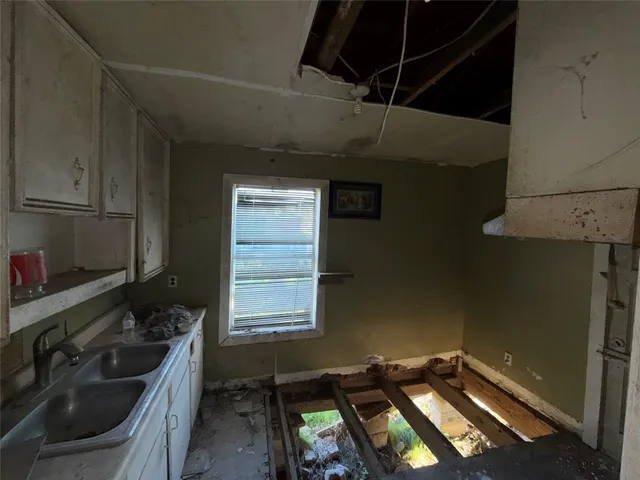 a kitchen with a sink stove and cabinets