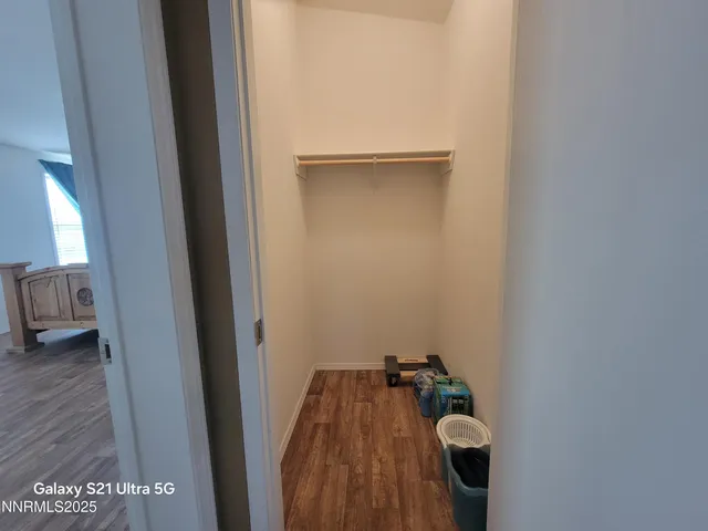 a view of a room with wooden floor