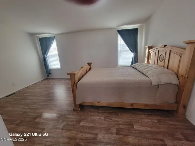 a bedroom with a bed and window