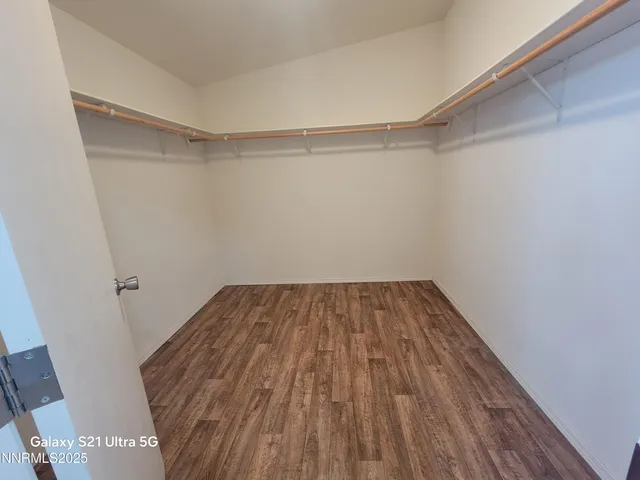 a view of a room with wooden floor