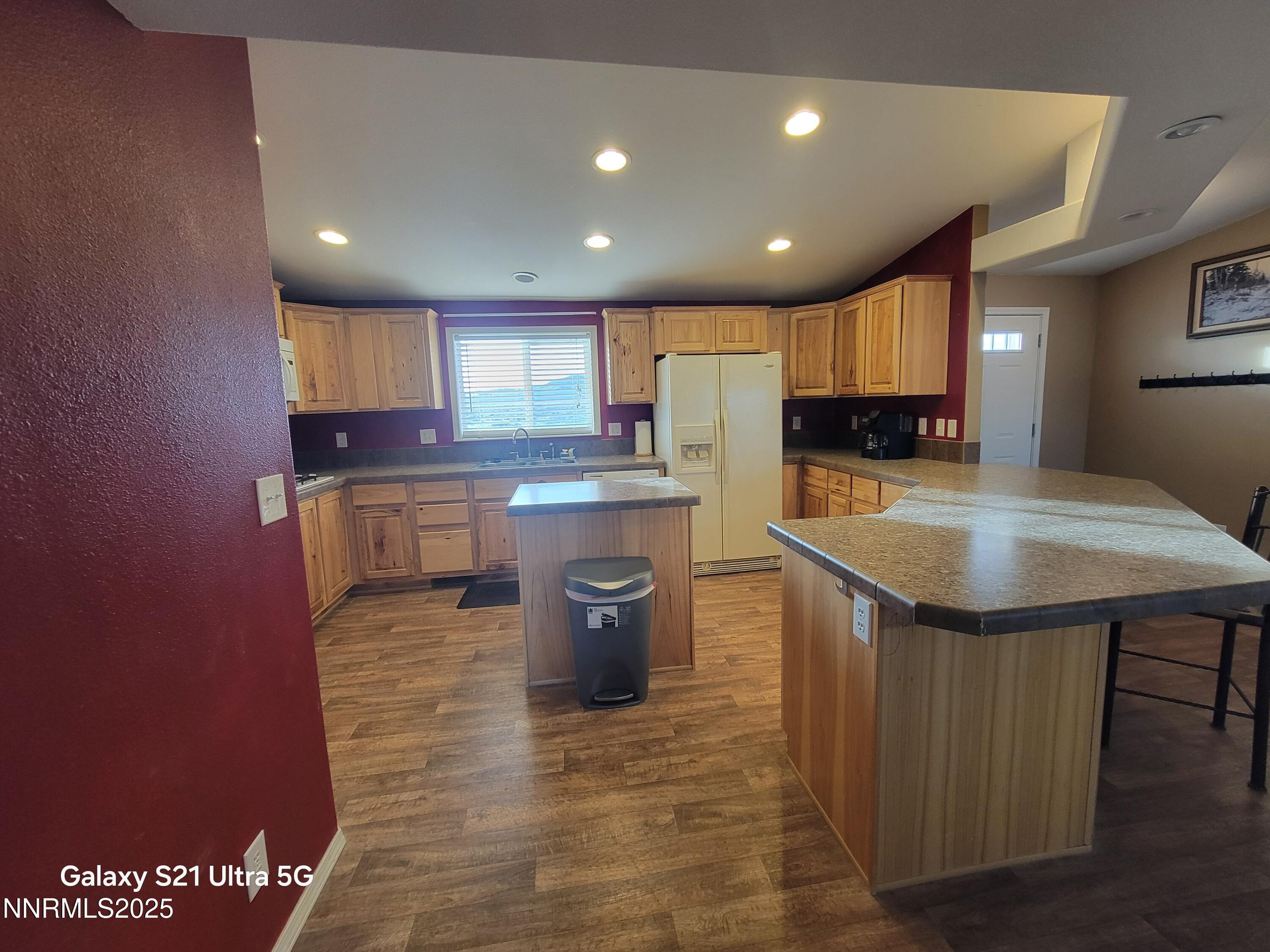 6650 Antelope Circle Austin, NV 89310 - Photo 7 of 25 a kitchen with stainless steel appliances granite countertop a sink wooden cabinets and granite counter tops