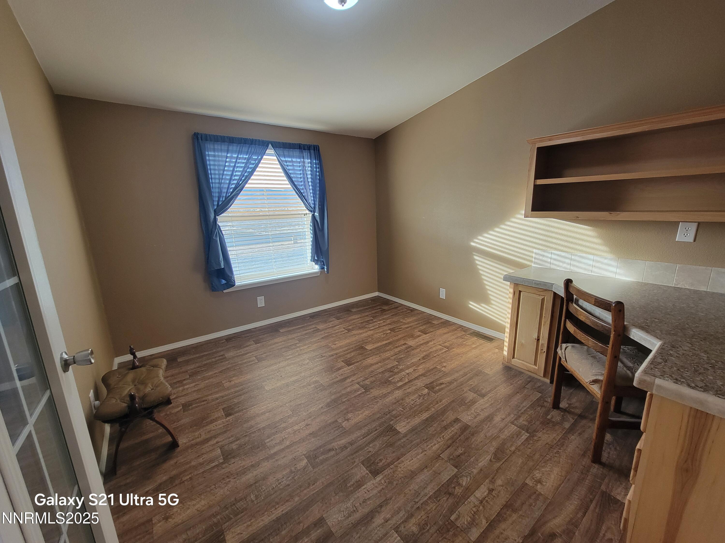 6650 Antelope Circle Austin, NV 89310 - Photo 9 of 25 an empty room with wooden floor fan and windows