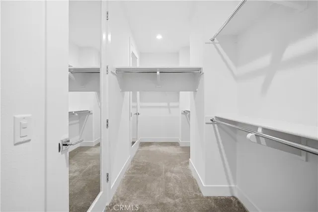 a dining room with wooden floor and white walls