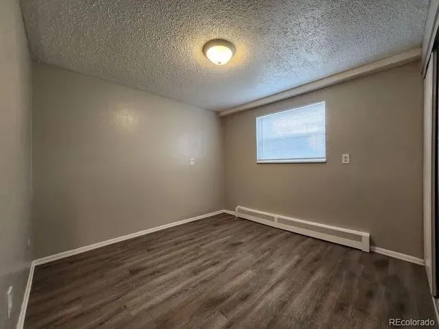 a kitchen with stainless steel appliances granite countertop a refrigerator sink and wooden cabinets
