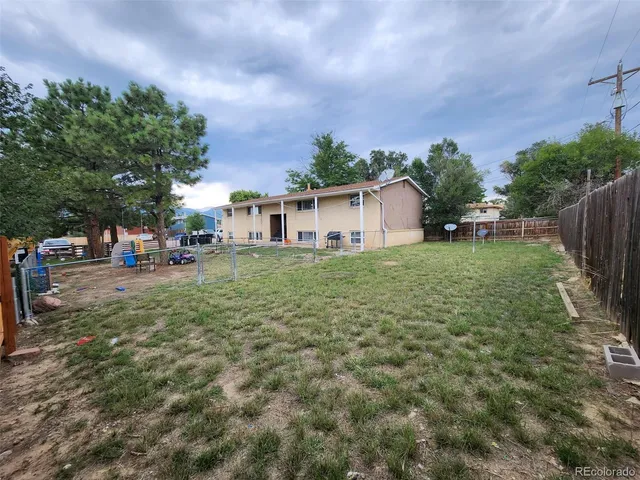 a view of a backyard with a garden and trees