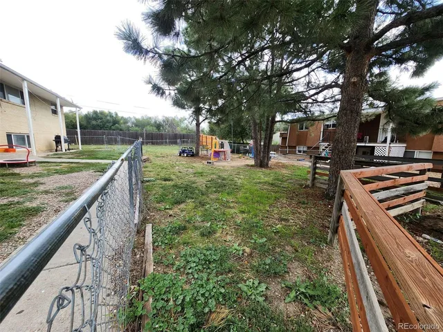 a backyard of a house with plants and tree