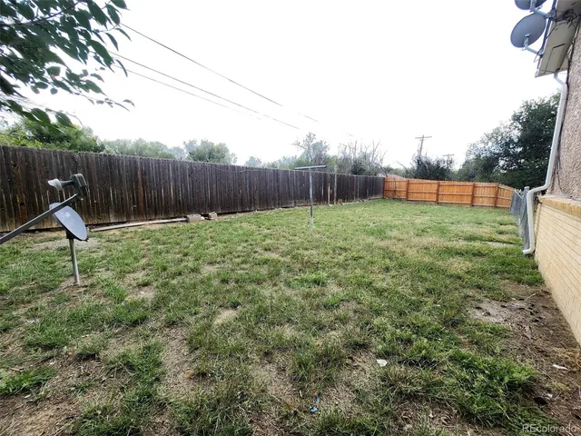 a kitchen with a sink a refrigerator a microwave and cabinets