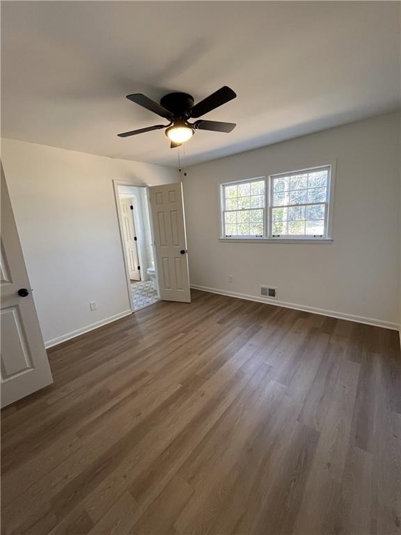 3425 New MacLand Road Powder Springs, GA 30127 - Photo 15 of 21 an empty room with wooden floor and windows