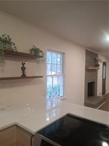 a kitchen with a window wooden floor and a sink
