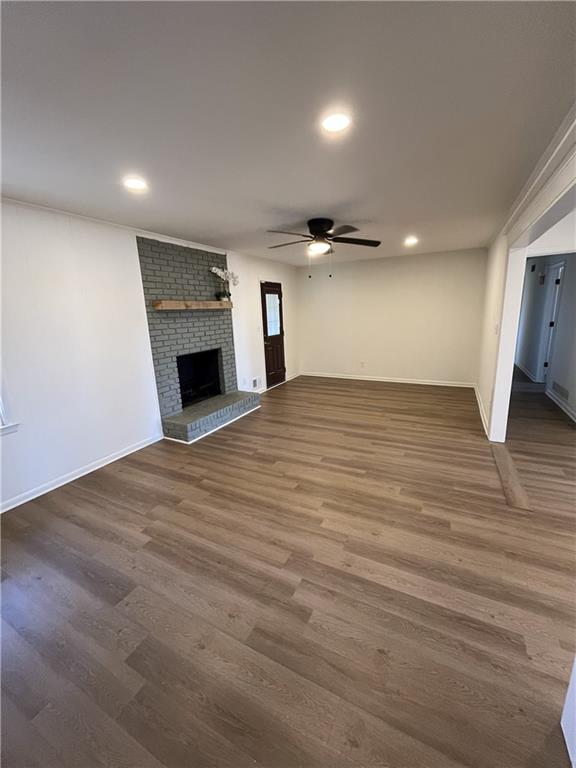 3425 New MacLand Road Powder Springs, GA 30127 - Photo 4 of 21 an empty room with wooden floor fireplace and windows