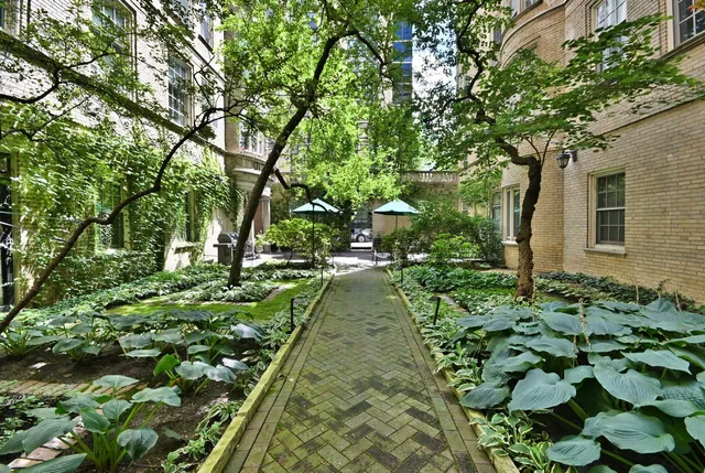 a view of a patio with furniture and umbrella
