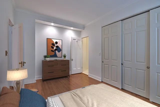 a bedroom with a bed and a lamp