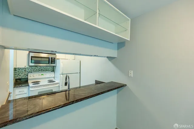 a kitchen with stainless steel appliances a sink and a stove
