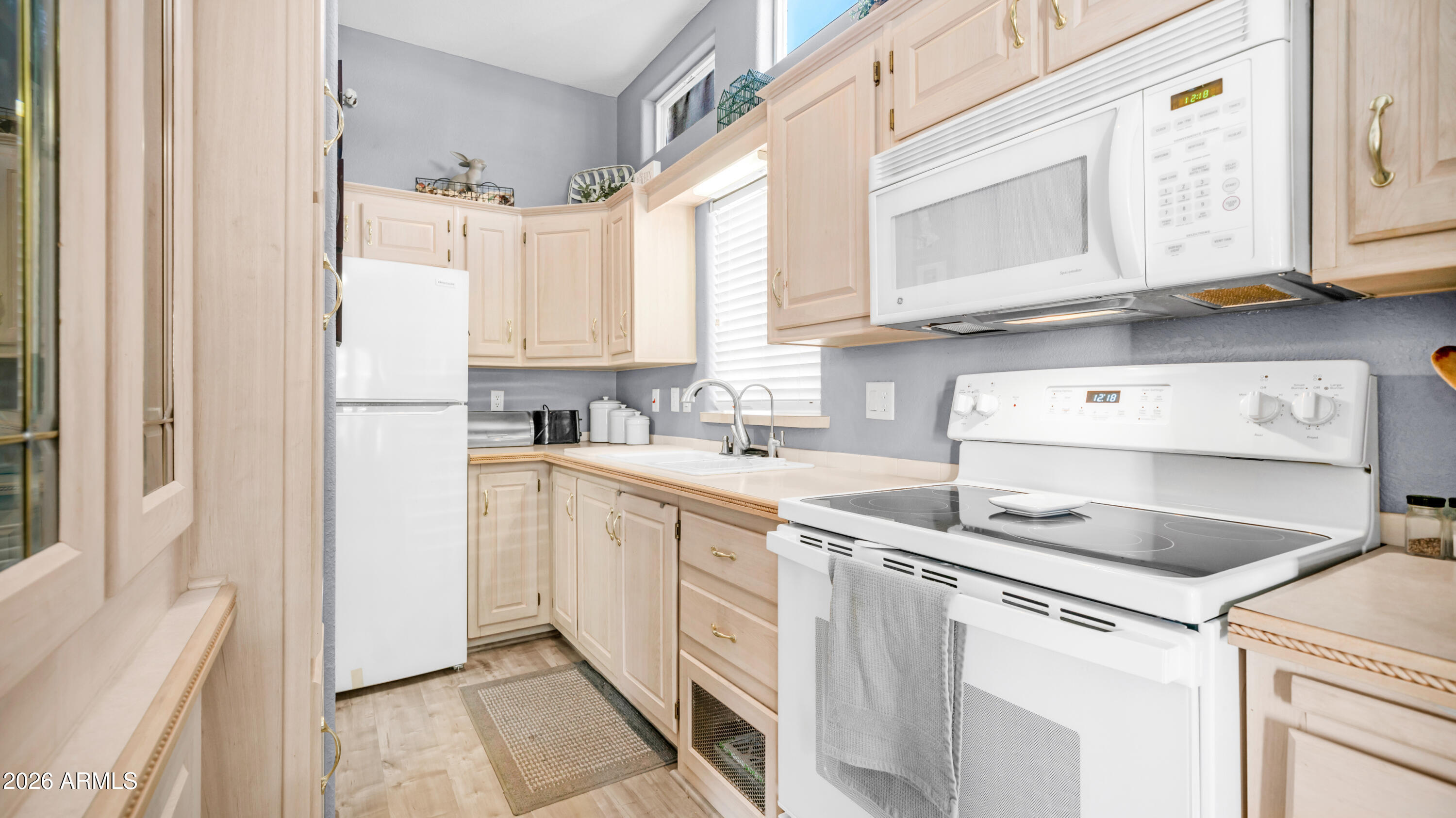 600 South Idaho Road Apache Junction, AZ 85119 - Photo 14 of 63 a kitchen with stainless steel appliances granite countertop a sink and a refrigerator