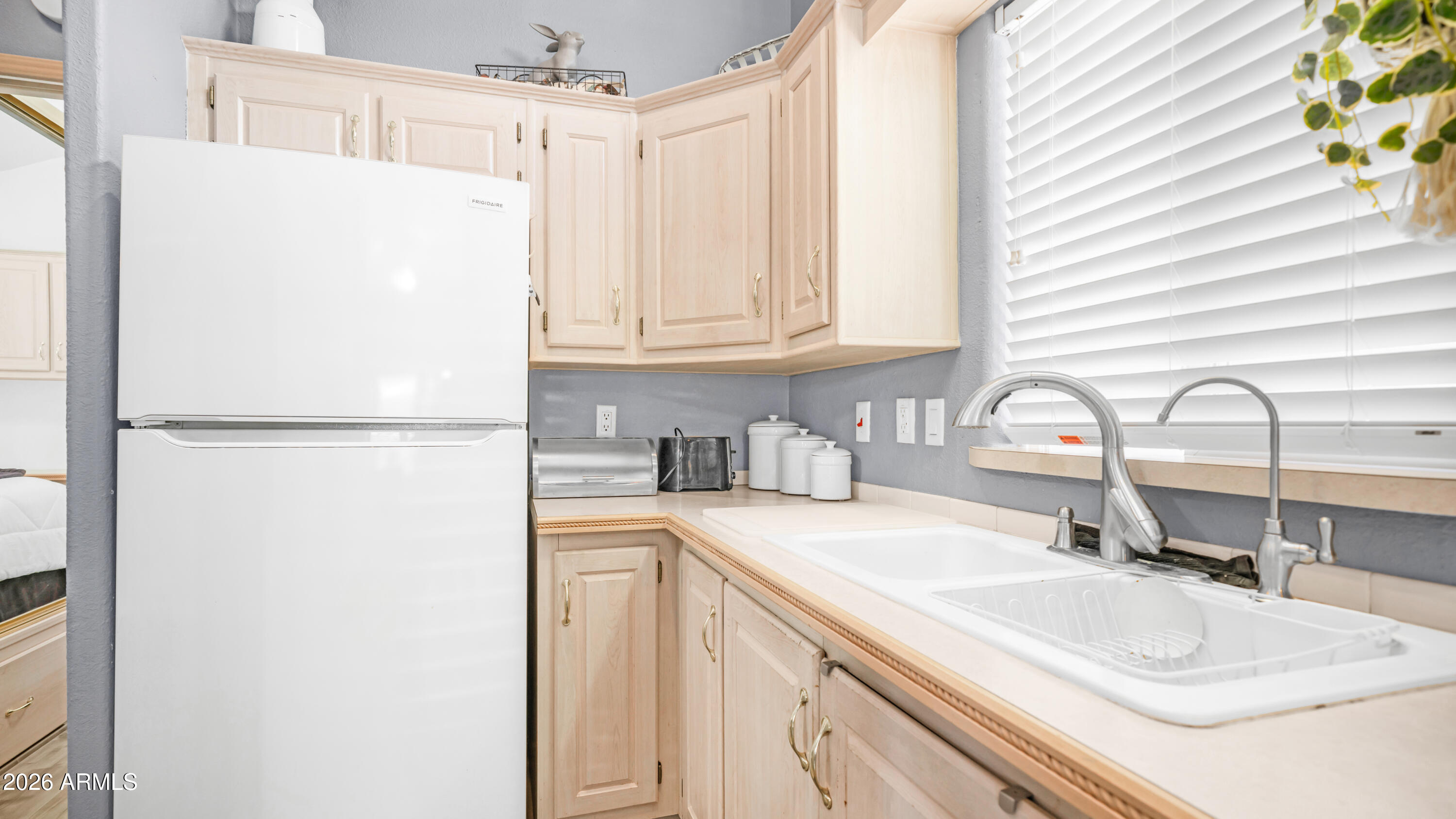 600 South Idaho Road Apache Junction, AZ 85119 - Photo 15 of 63 a kitchen with a sink and a refrigerator