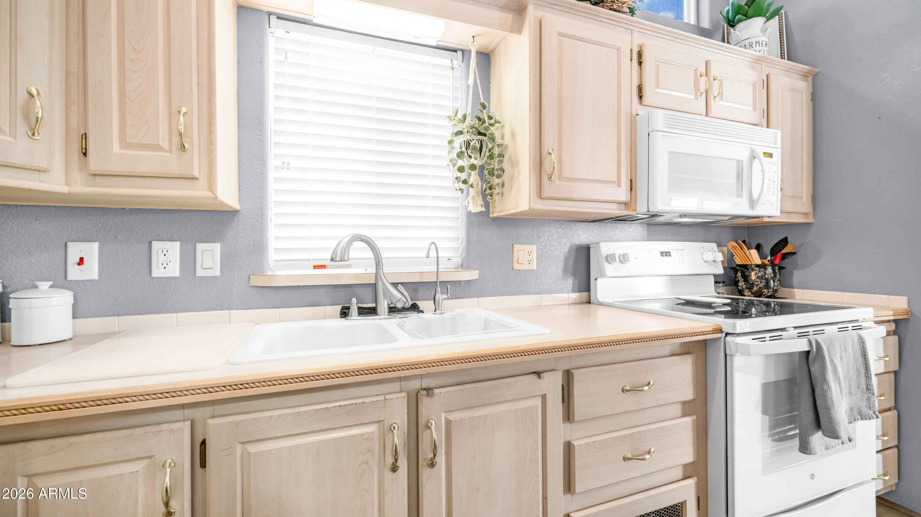600 South Idaho Road Apache Junction, AZ 85119 - Photo 16 of 63 a kitchen with appliances cabinets and a window