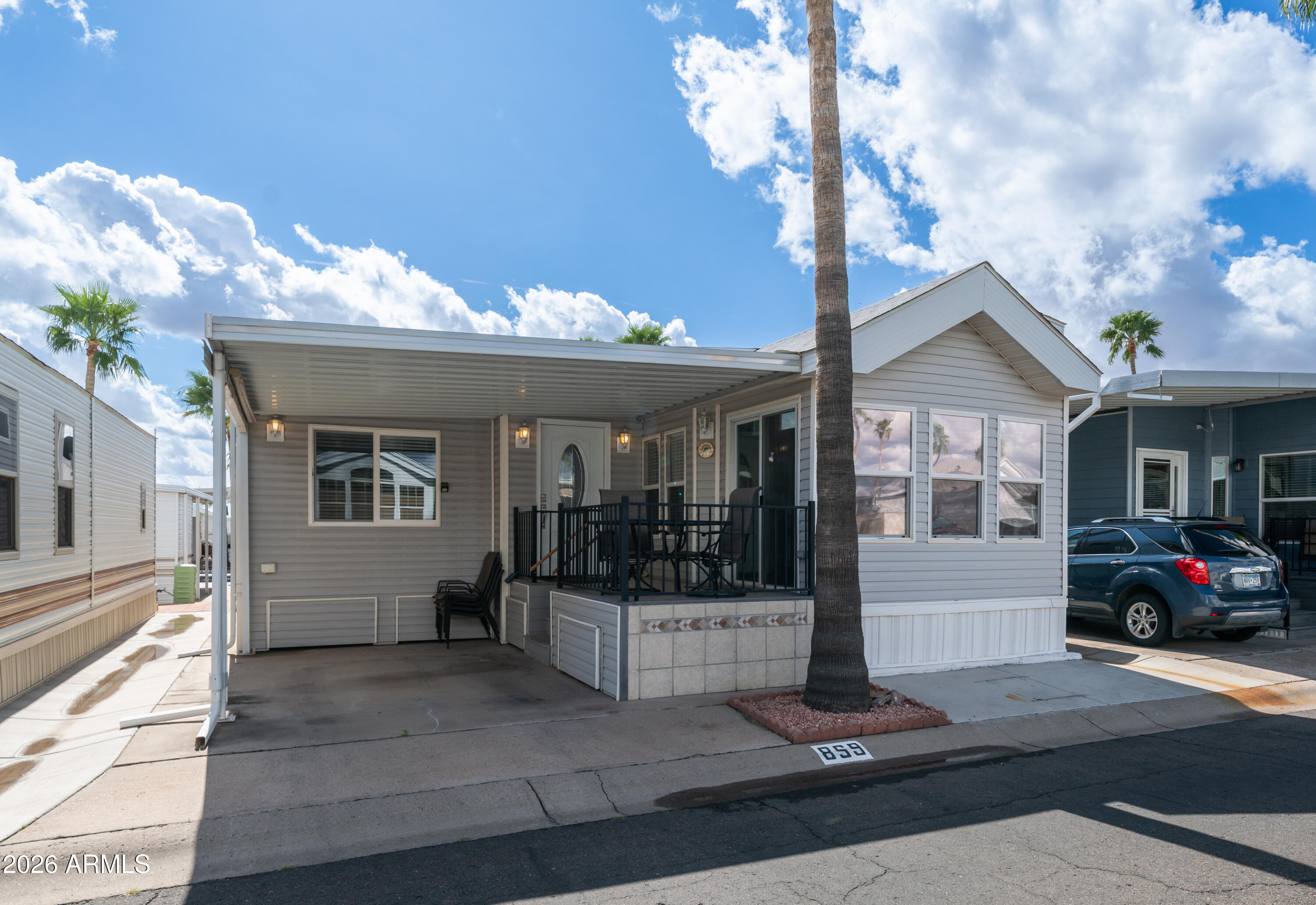 600 South Idaho Road Apache Junction, AZ 85119 - Photo 2 of 63 a front view of a house with a garden