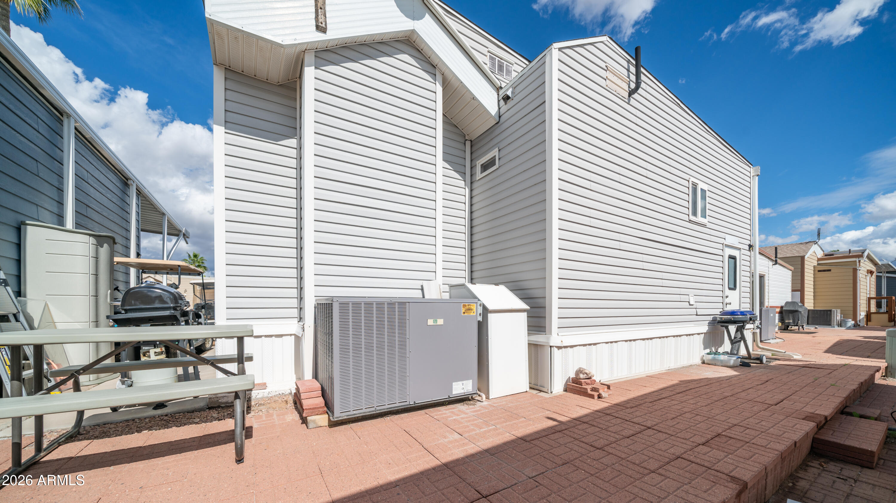 600 South Idaho Road Apache Junction, AZ 85119 - Photo 28 of 63 a view of a patio with couches and table and chairs with wooden floor and fence