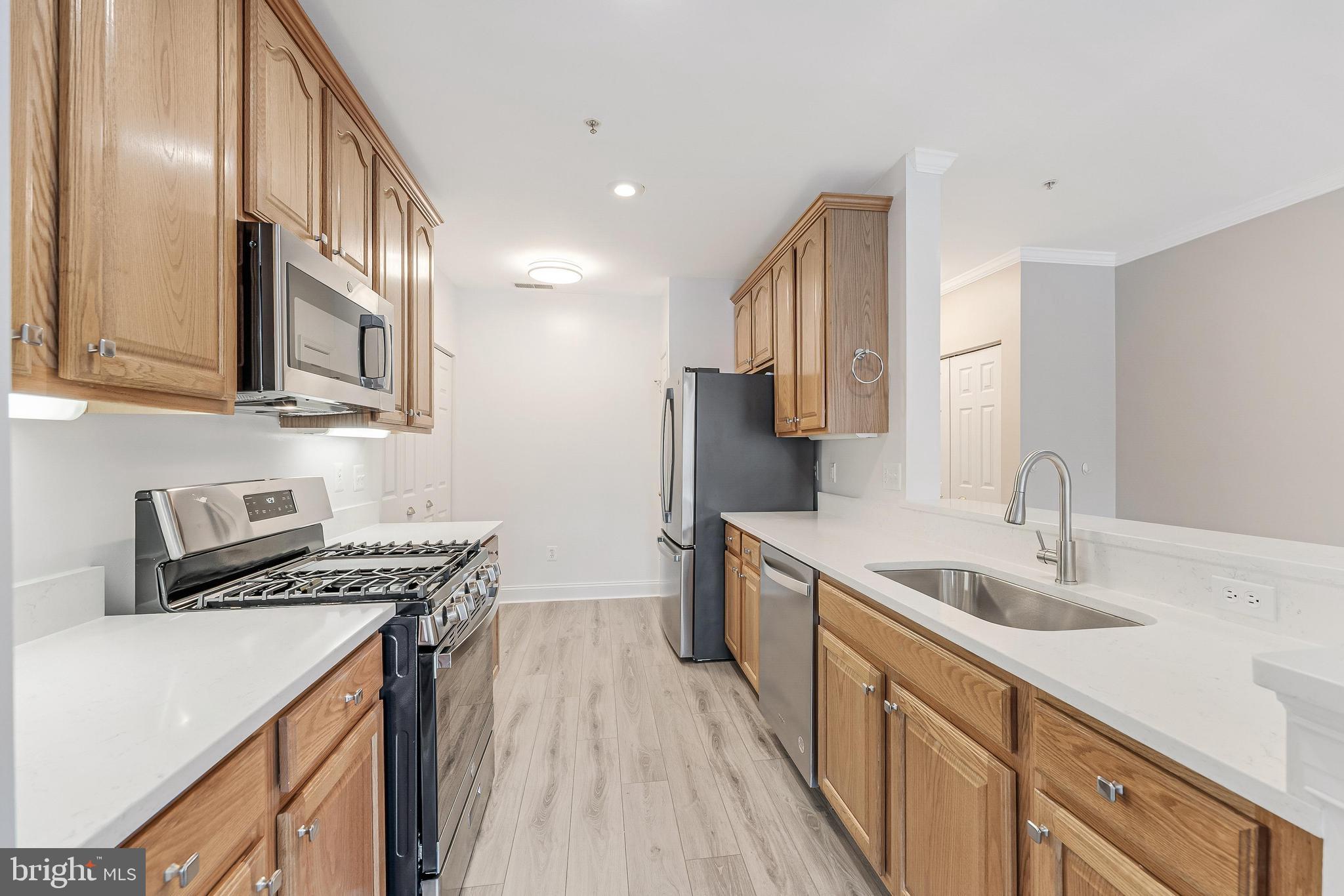25280 Lake Shore Square, Unit 102 Chantilly, VA 20152 - Photo 11 of 41 a kitchen that has a sink and a stove