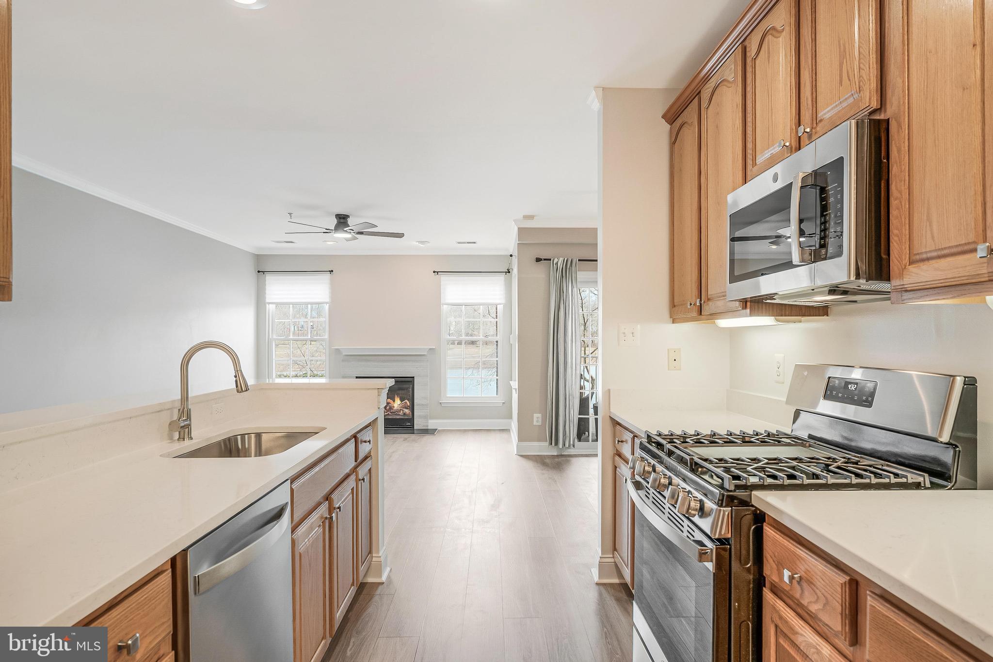 25280 Lake Shore Square, Unit 102 Chantilly, VA 20152 - Photo 15 of 41 a kitchen with a sink stove and cabinets