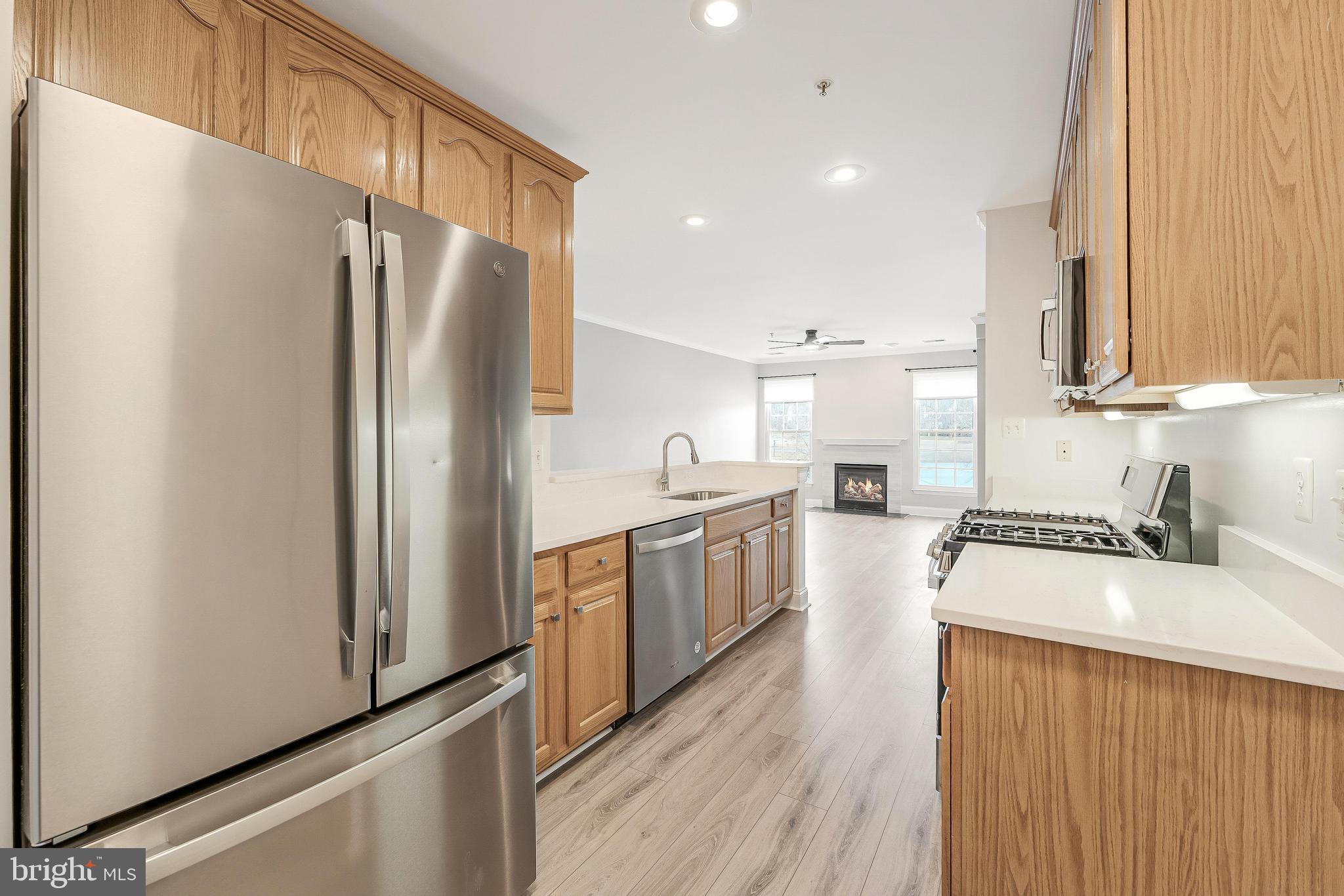25280 Lake Shore Square, Unit 102 Chantilly, VA 20152 - Photo 17 of 41 a kitchen with stainless steel appliances a refrigerator sink and cabinets
