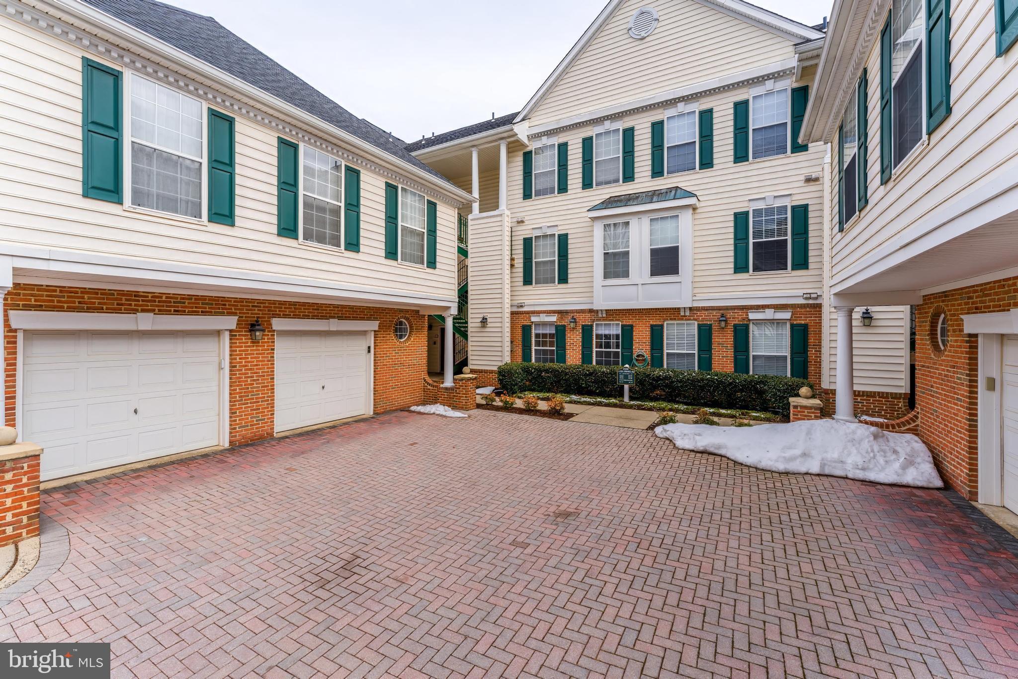 25280 Lake Shore Square, Unit 102 Chantilly, VA 20152 - Photo 2 of 41 a front view of a house with yard