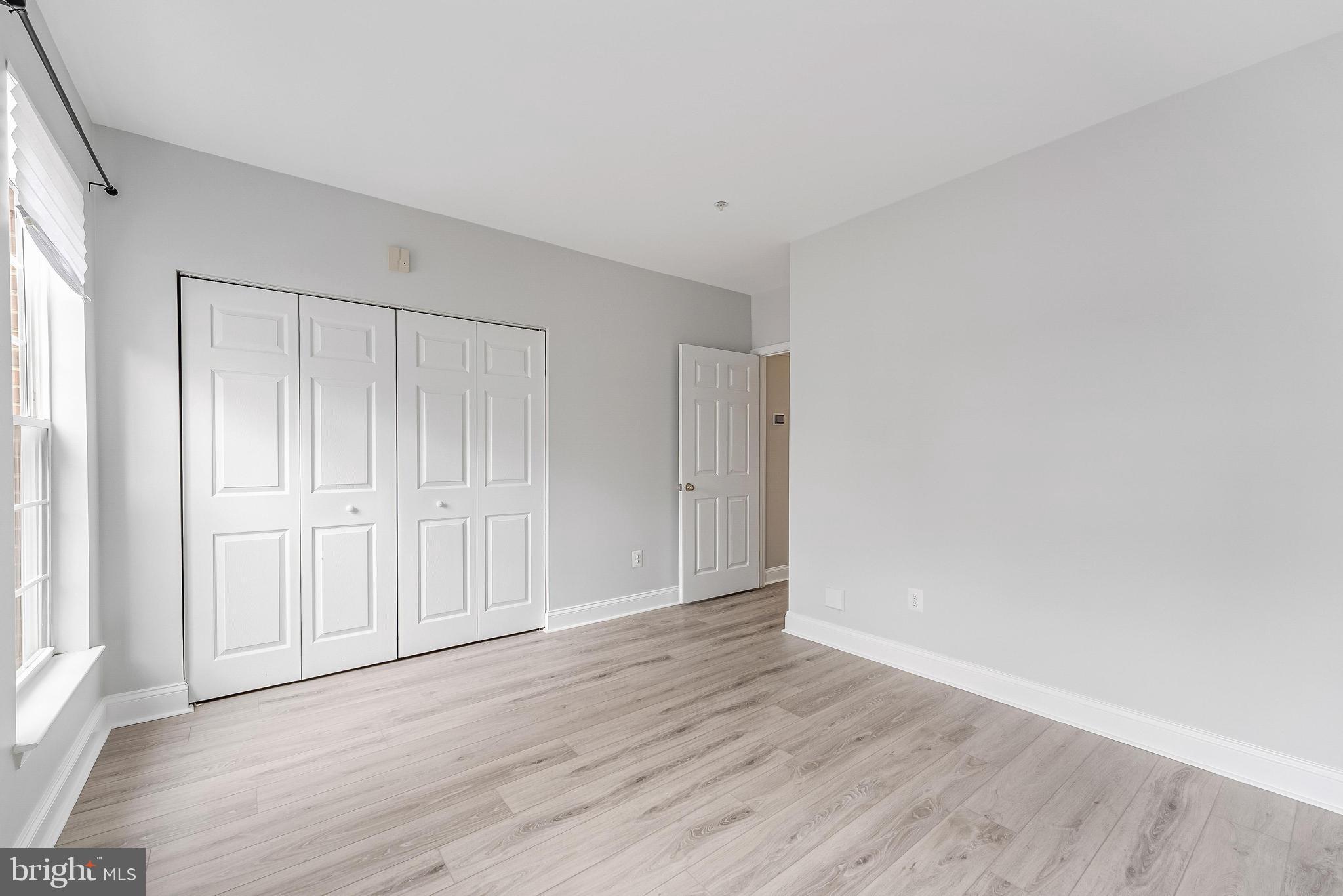 25280 Lake Shore Square, Unit 102 Chantilly, VA 20152 - Photo 22 of 41 a view of an empty room and wooden floor