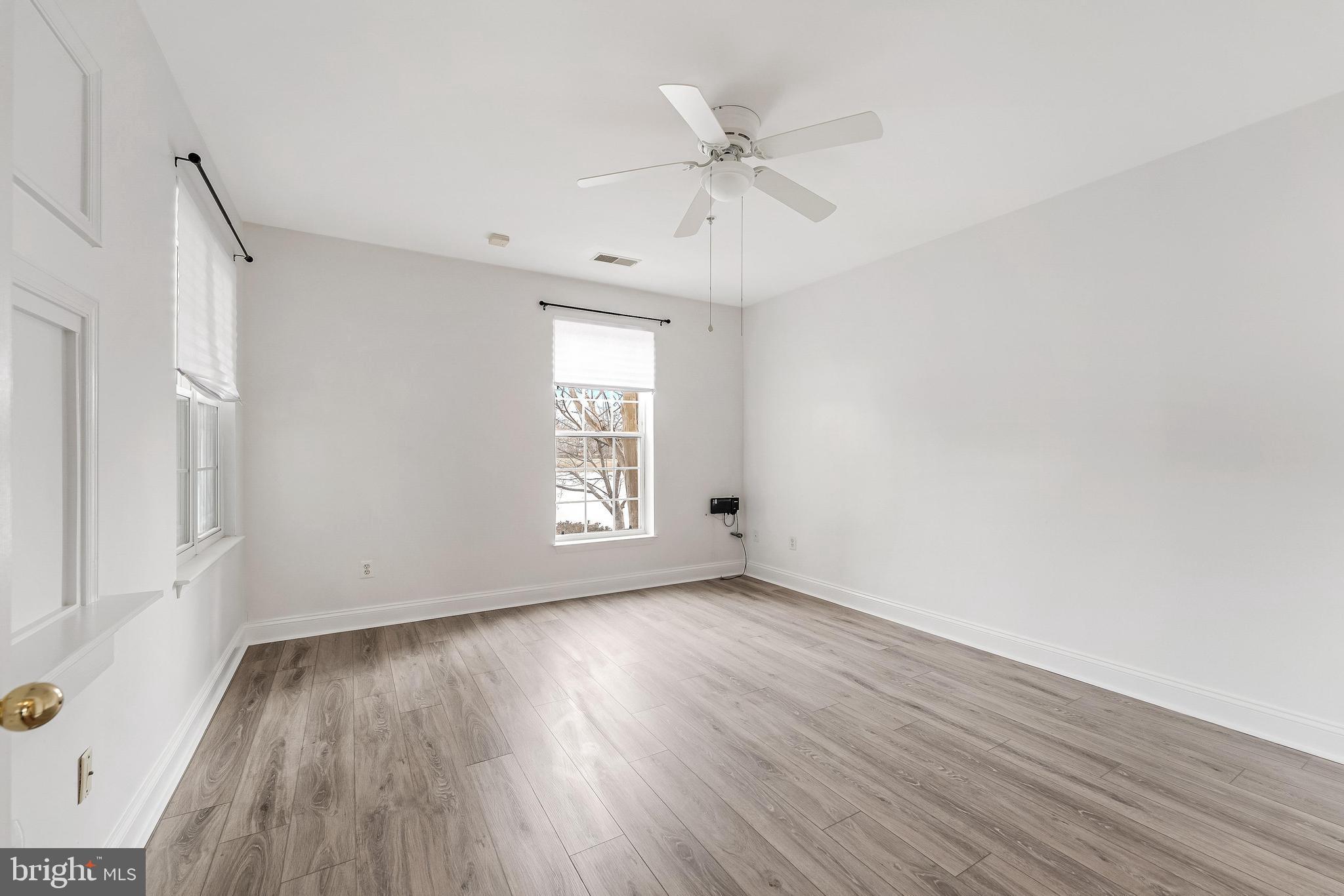 25280 Lake Shore Square, Unit 102 Chantilly, VA 20152 - Photo 23 of 41 a view of an empty room with wooden floor and a window