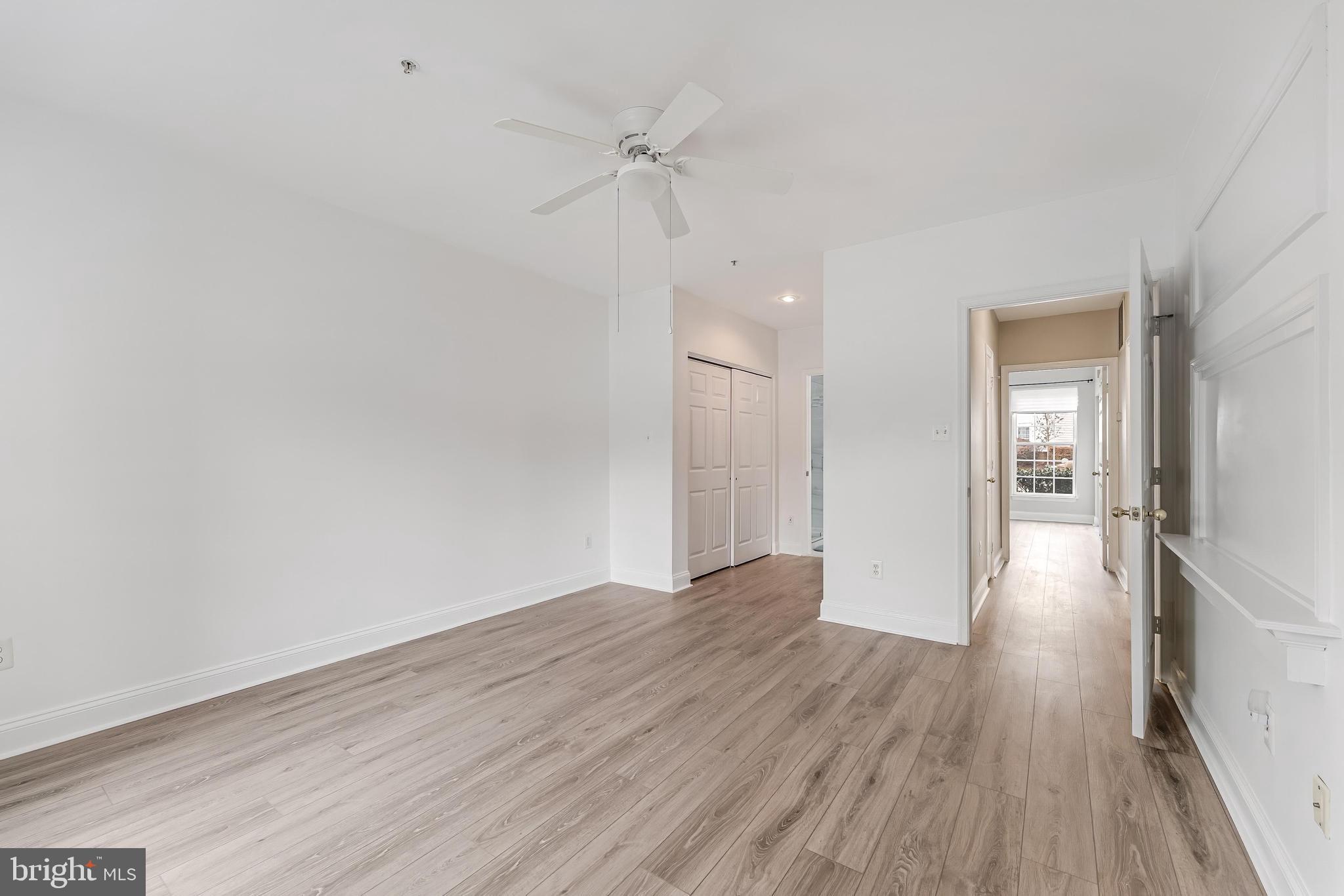 25280 Lake Shore Square, Unit 102 Chantilly, VA 20152 - Photo 24 of 41 a view of a room with wooden floor and a ceiling fan