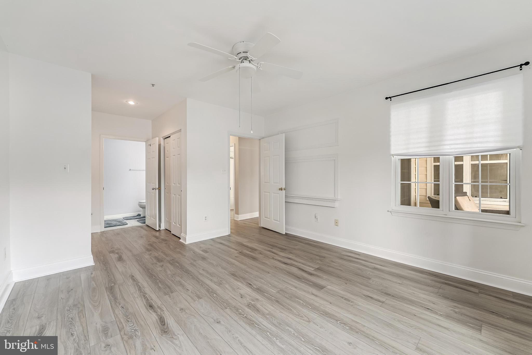 25280 Lake Shore Square, Unit 102 Chantilly, VA 20152 - Photo 25 of 41 a view of an empty room with wooden floor and a window