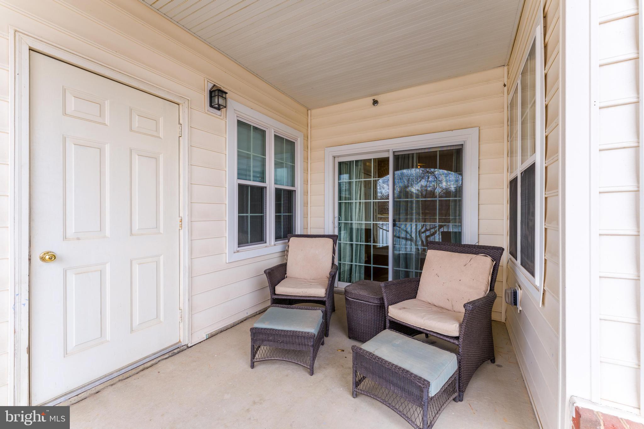 25280 Lake Shore Square, Unit 102 Chantilly, VA 20152 - Photo 30 of 41 a balcony with furniture and large windows