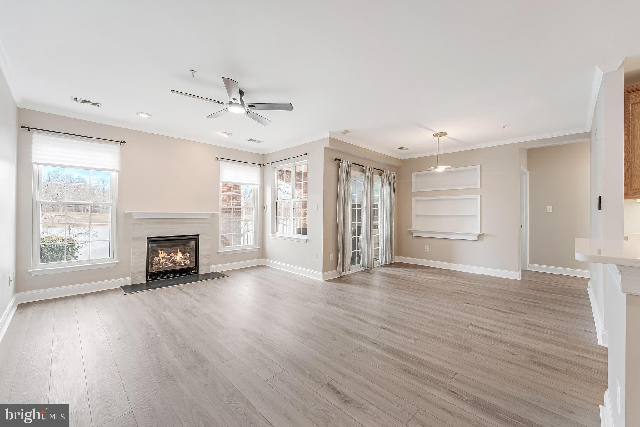 25280 Lake Shore Square, Unit 102 Chantilly, VA 20152 - Photo 6 of 41 wooden floor fireplace and windows in an empty room