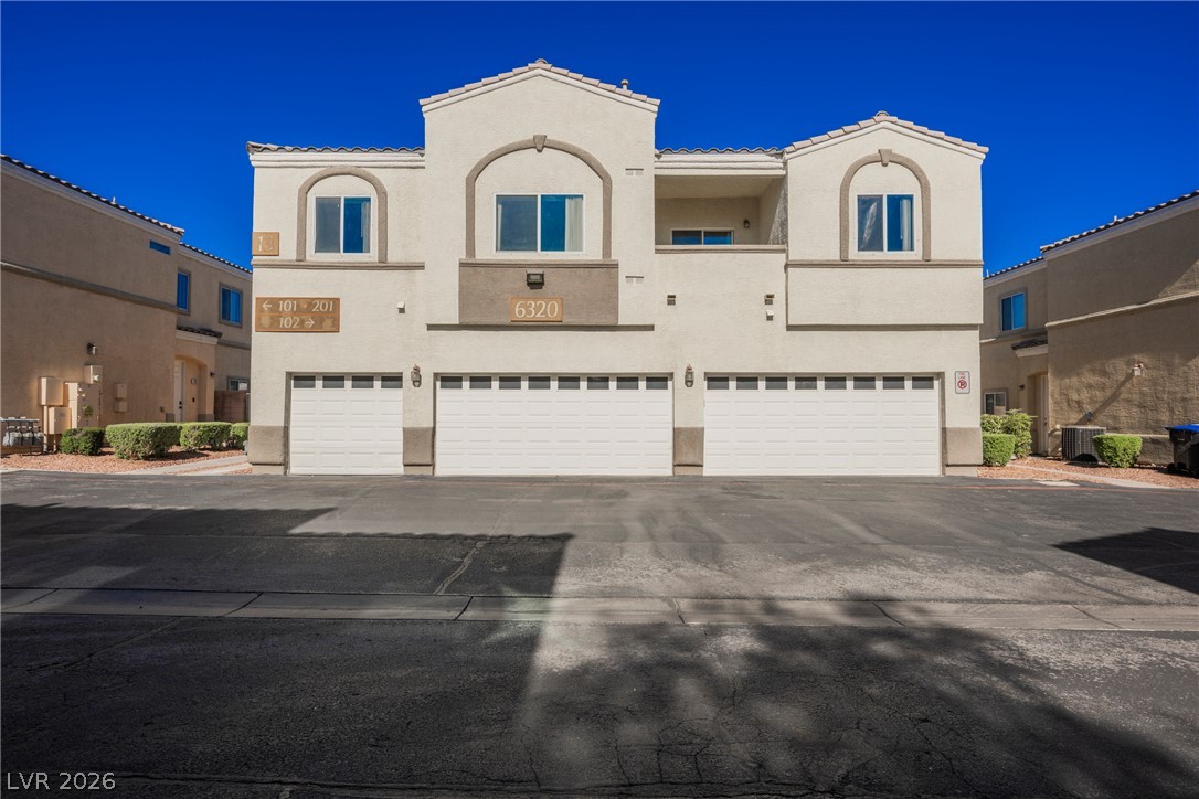 6320 Snap Ridge Street, Unit 201 North Las Vegas, NV 89081 - Photo 49 of 56 A striking condominium building with integrated garages and crisp architectural lines awaits.